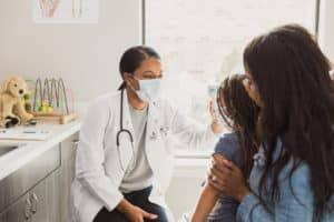 Child receiving a routine health checkup from a paediatrician for healthy growth and development